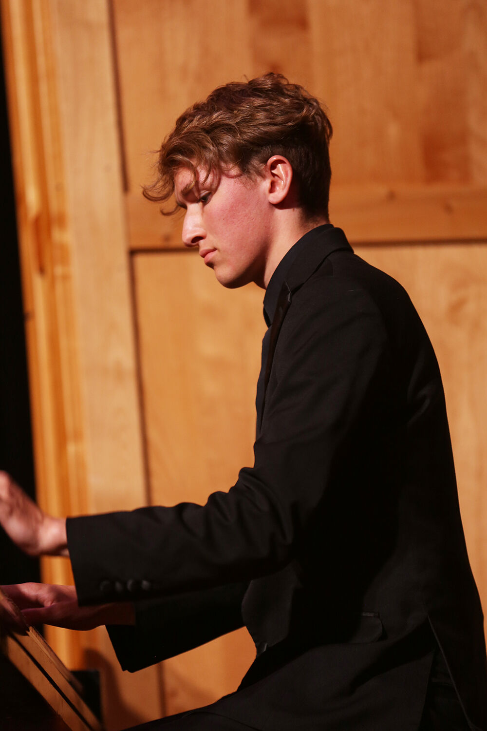Tim Clason offers a solo on the piano between choir performances